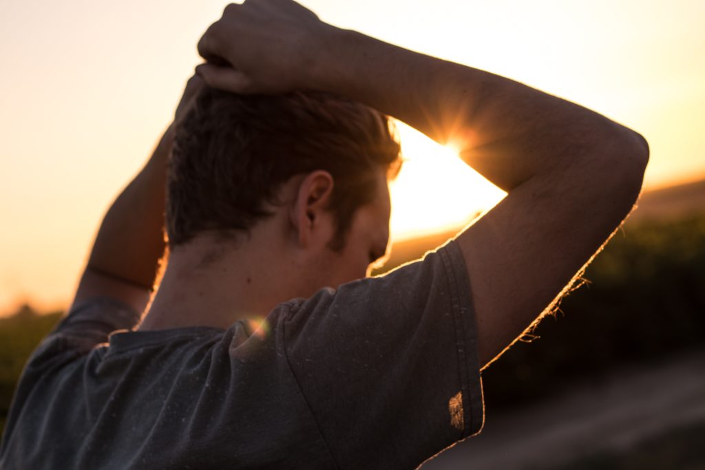 Man standing in front of a sunset
