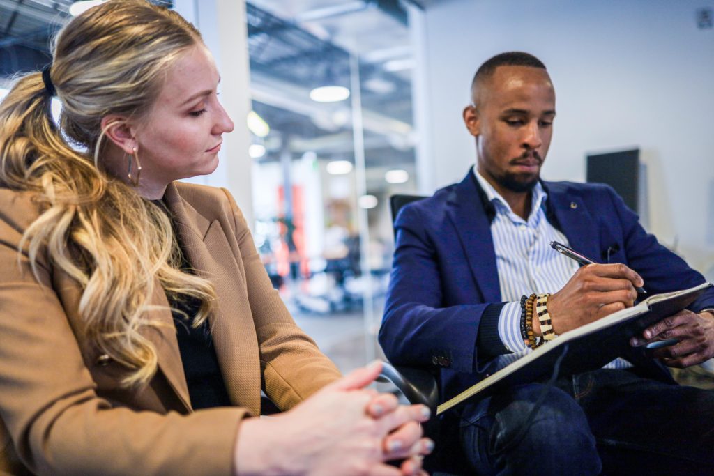 man and woman in a meeting, hiring and firing tips for executive pastors